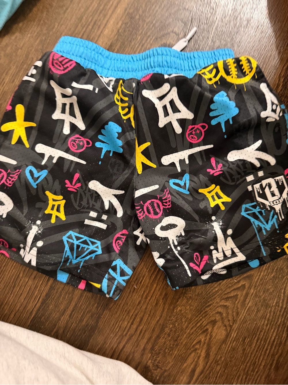 Kids Black Graffiti Print Swim Shorts with Blue Waistband